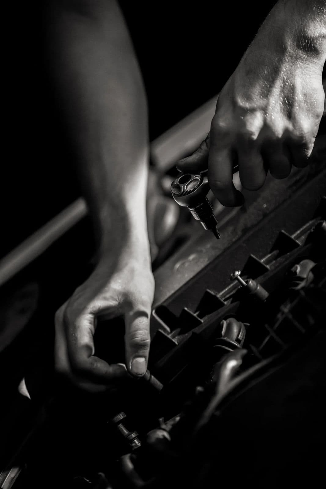 Technician's hands working in the engine bay